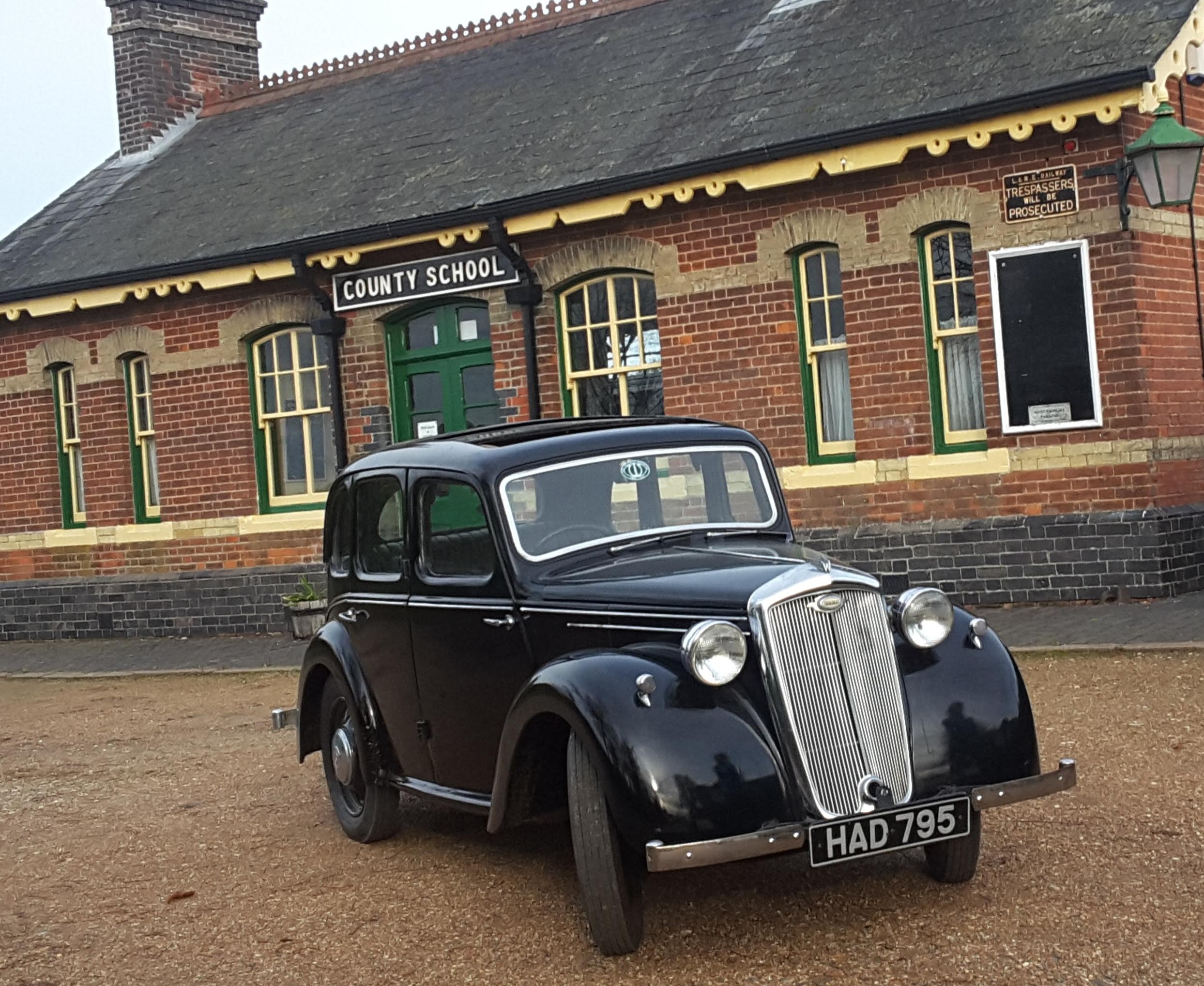 1947 Wolseley Eight parked outside the old County School station building